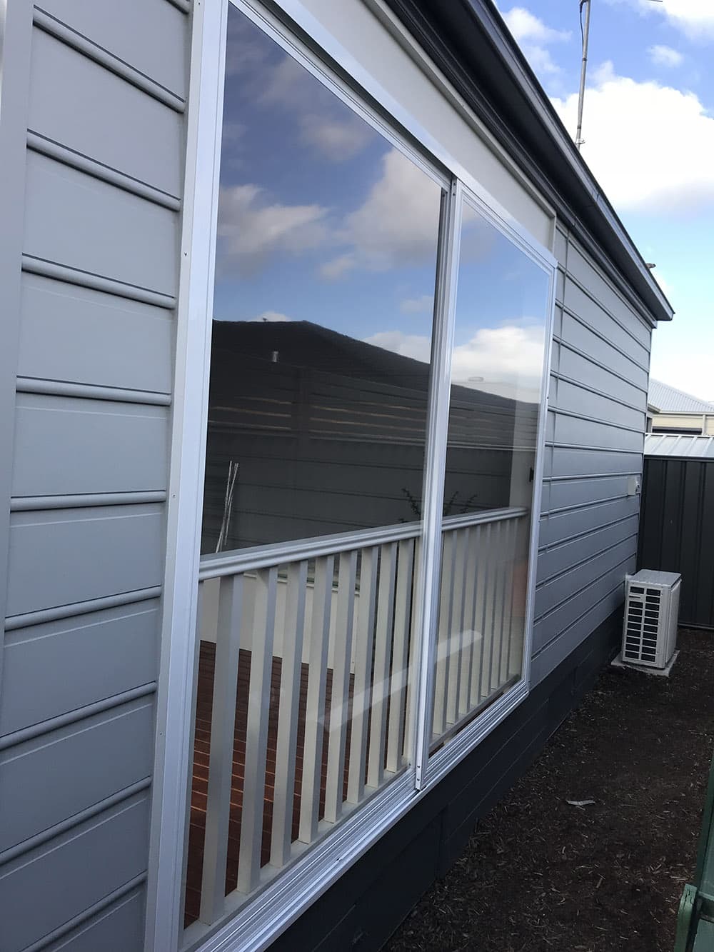 Family courtyard enclosed with clear PVC weather screens